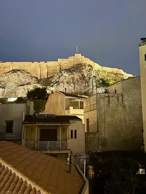 a building with a mountain in the background at Plaka Two-Bedroom Flat with Acropolis View Terrace in Athens