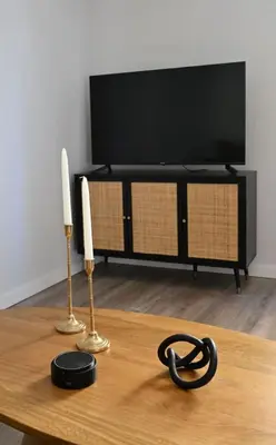 a table with two candles and a television on a tv stand at Plaka Two-Bedroom Flat with Acropolis View Terrace in Athens