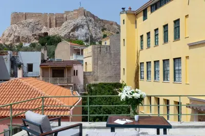 a balcony with a table and a view of a castle at Plaka Two-Bedroom Flat with Acropolis View Terrace in Athens