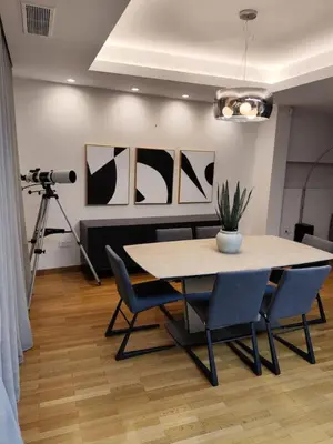 a dining room with a table and chairs and a camera at Monastiraki 2 Bedroom Acropolis View with Terrace in Athens