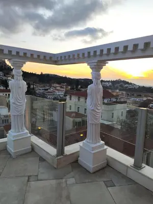 a balcony with two white columns on top of a building at Monastiraki 2 Bedroom Acropolis View with Terrace in Athens