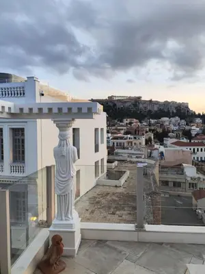 a statue on the roof of a building with a city at Monastiraki 2 Bedroom Acropolis View with Terrace in Athens