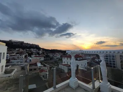 a view of a city at sunset from a building at Monastiraki 2 Bedroom Acropolis View with Terrace in Athens