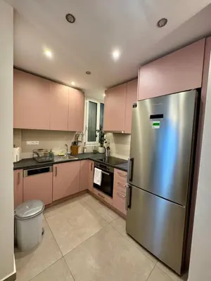 a kitchen with pink cabinets and a stainless steel refrigerator at Acropoli 1 Bedroom Flat with Rooftop Acropolis View in Athens