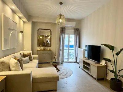 a living room with a couch and a tv at Acropoli 1 Bedroom Flat with Rooftop Acropolis View in Athens