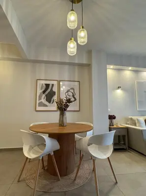a dining room with a wooden table and white chairs at Acropoli 1 Bedroom Flat with Rooftop Acropolis View in Athens