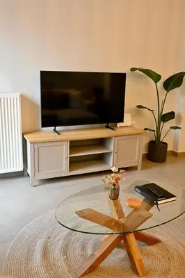 a living room with a television and a coffee table at Acropoli 1 Bedroom Flat with Rooftop Acropolis View in Athens