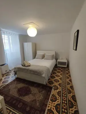 a bedroom with a bed and a rug at Filopappou 1 bedroom Flat in Athens