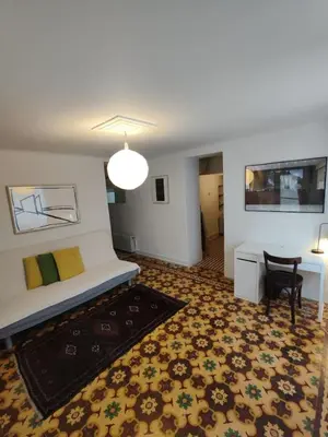 a room with a bed and a table and a chair at Filopappou 1 bedroom Flat in Athens