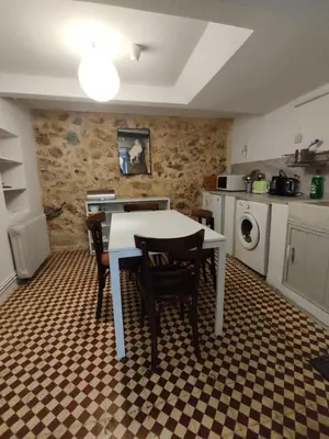 a kitchen with a table and chairs in a room at Filopappou 1 bedroom Flat in Athens