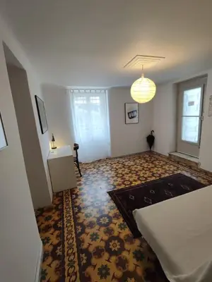 a living room with a bed and a rug at Filopappou 1 bedroom Flat in Athens
