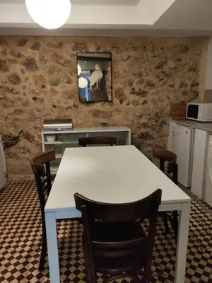 a kitchen with a white table and chairs at Filopappou 1 bedroom Flat in Athens