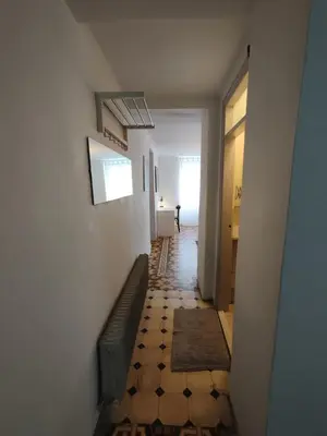 a hallway with a green couch and a hallway with a hallwayngthngthngthngth at Filopappou 1 bedroom Flat in Athens