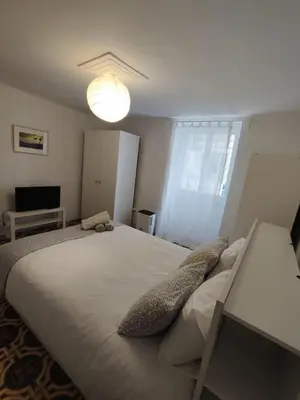 a bedroom with a large white bed with pillows at Filopappou 1 bedroom Flat in Athens
