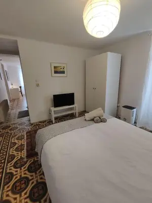 a bedroom with a large bed with a stuffed animal on it at Filopappou 1 bedroom Flat in Athens