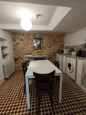 a kitchen with a table and chairs in a room at Filopappou 1 bedroom Flat in Athens