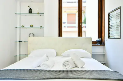 a bedroom with a white bed with towels on it at Modern Flat in Central Athens - Lavatera in Athens