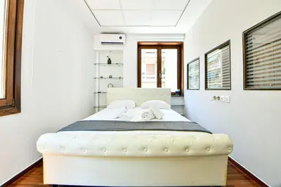 a bedroom with a white bed in a room at Modern Flat in Central Athens - Lavatera in Athens