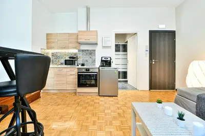 a kitchen and living room with a couch and a table at Modern Flat in Central Athens - Lavatera in Athens