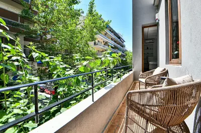 a balcony with chairs and plants on a building at Modern Flat in Central Athens - Lavatera in Athens