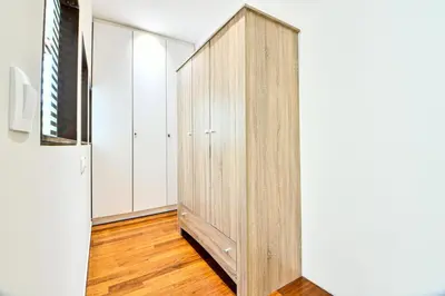 a wooden wardrobe in a room with wooden floors at Modern Flat in Central Athens - Lavatera in Athens