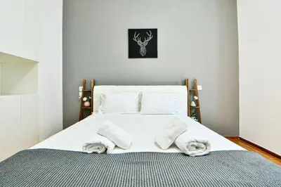 a bedroom with a bed with towels on it at Cozy Flat in Central Athens - Iris in Athens