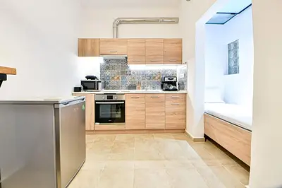 a kitchen with wooden cabinets and a sink at Cozy Flat in Central Athens - Iris in Athens
