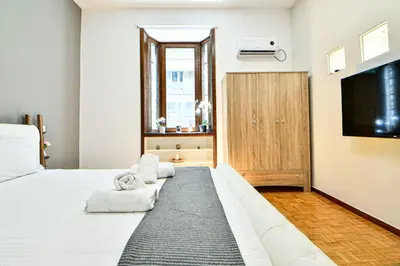 a bedroom with a large bed and a flat screen tv at Cozy Flat in Central Athens - Iris in Athens