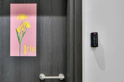 a door with a sign with a flower on it at Cozy Flat in Central Athens - Iris in Athens
