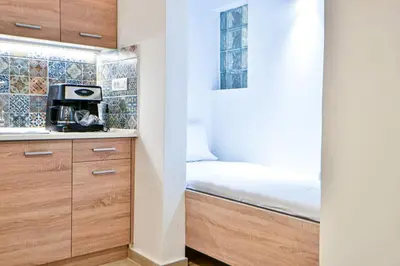 a small bedroom with a bed and a microwave at Cozy Flat in Central Athens - Iris in Athens
