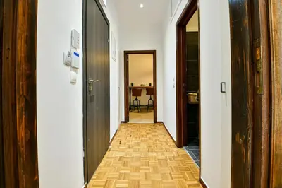 a hallway with white walls and a wooden floor at Cozy Flat in Central Athens - Iris in Athens