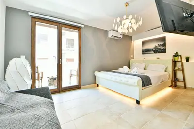 a bedroom with a bed and a tv on the wall at Cozy Flat in Central Athens - Papaver in Athens