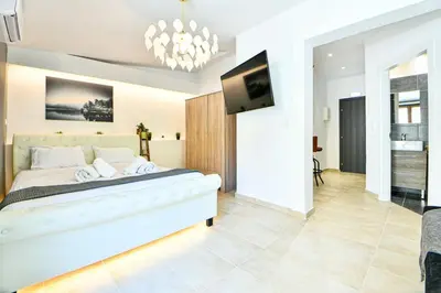 a bedroom with a bed and a flat screen tv at Cozy Flat in Central Athens - Papaver in Athens