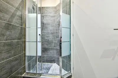 a shower with a glass door in a bathroom at Cozy Flat in Central Athens - Papaver in Athens