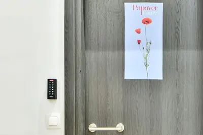 a door with a sign on it with a flower on it at Cozy Flat in Central Athens - Papaver in Athens