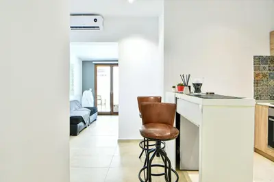 a kitchen with a counter and a stool in a room at Cozy Flat in Central Athens - Papaver in Athens
