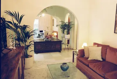 a living room with a couch and a table at Newly Renovated Apartment in a Lush Green Neighborhood in Central Athens in Athens