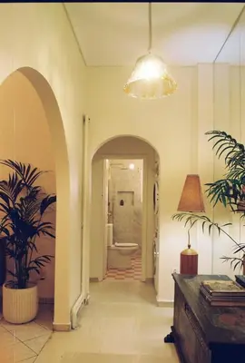 a hallway with a room with a toilet and a light at Newly Renovated Apartment in a Lush Green Neighborhood in Central Athens in Athens