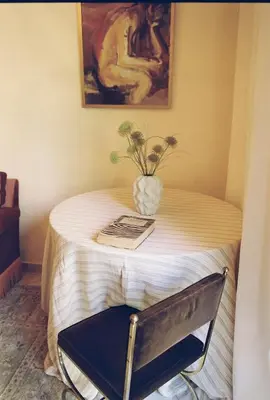a small table with a vase on top of it at Newly Renovated Apartment in a Lush Green Neighborhood in Central Athens in Athens