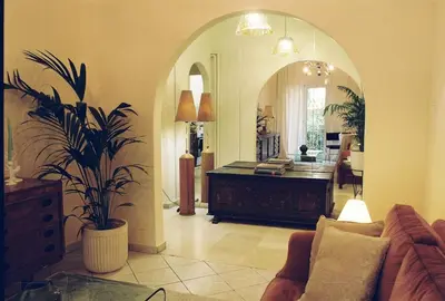 a living room with a couch and a mirror at Newly Renovated Apartment in a Lush Green Neighborhood in Central Athens in Athens
