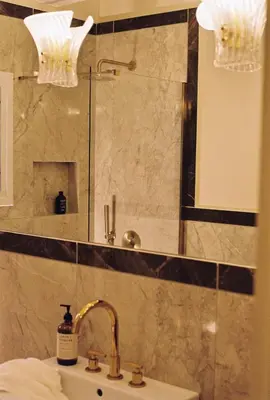 a bathroom with a sink and a shower with a mirror at Newly Renovated Apartment in a Lush Green Neighborhood in Central Athens in Athens