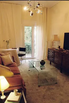 a living room with a couch and a glass table at Newly Renovated Apartment in a Lush Green Neighborhood in Central Athens in Athens