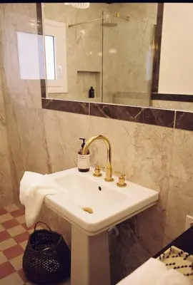 a bathroom with a sink and a mirror at Newly Renovated Apartment in a Lush Green Neighborhood in Central Athens in Athens