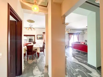 a dining room and living room with a table and chairs at Thiseio Villa Acropolis View in Athens