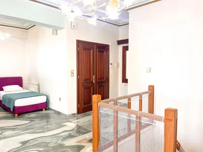 a room with a bed and a staircase with a door at Thiseio Villa Acropolis View in Athens