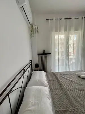 a bedroom with a bed and a window at The Central Athens Thission in Athens