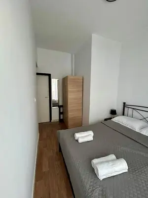 a bedroom with a bed with two towels on it at The Central Athens Thission in Athens
