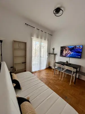 a bedroom with a bed and a table and a tv at The Central Athens Thission in Athens