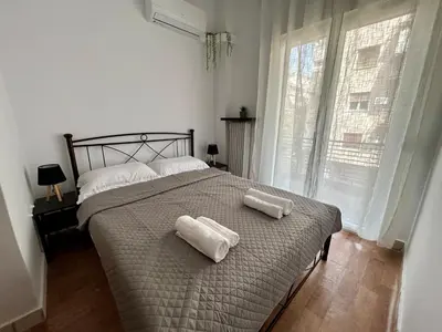 a bedroom with a bed with two towels on it at The Central Athens Thission in Athens
