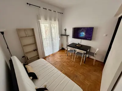 a bedroom with a bed and a desk with a television at The Central Athens Thission in Athens